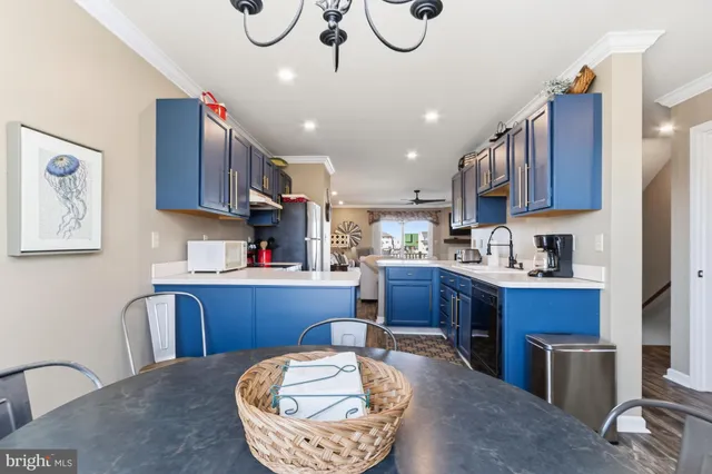a kitchen with stainless steel appliances granite countertop a refrigerator sink and stove