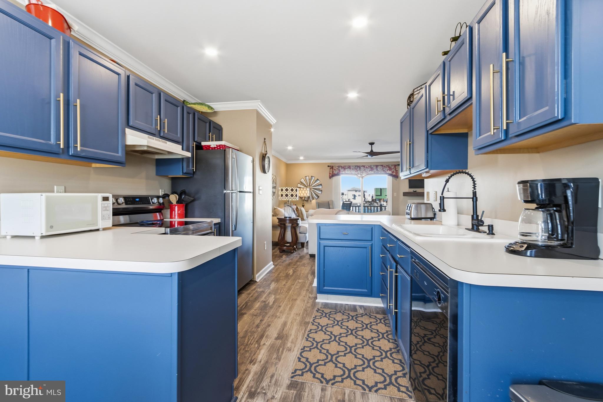 37896 Marina Road, Unit 4 Ocean View, DE 19970 - Photo 9 of 78 a kitchen with stainless steel appliances granite countertop a sink stove and refrigerator