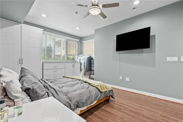 a bedroom with a large bed and a flat screen tv