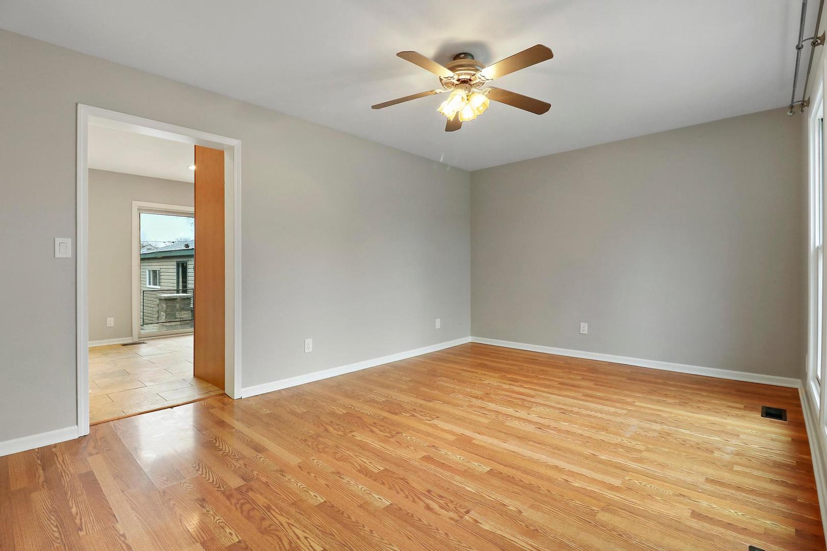 419 Foster Road Wauconda, IL 60084 - Photo 2 of 21 an empty room with wooden floor and chandelier fan