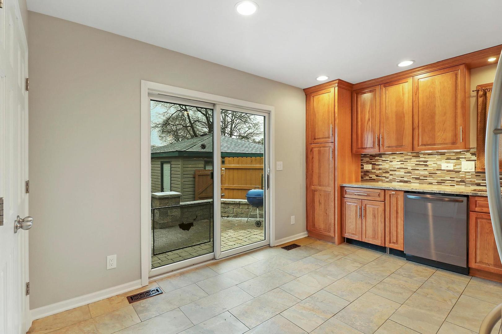 419 Foster Road Wauconda, IL 60084 - Photo 4 of 21 a view of kitchen with granite countertop cabinets and refrigerator