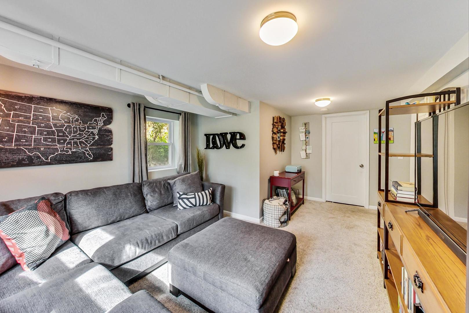 138 Northgate Road Riverside, IL 60546 - Photo 9 of 30 a living room with furniture and a flat screen tv