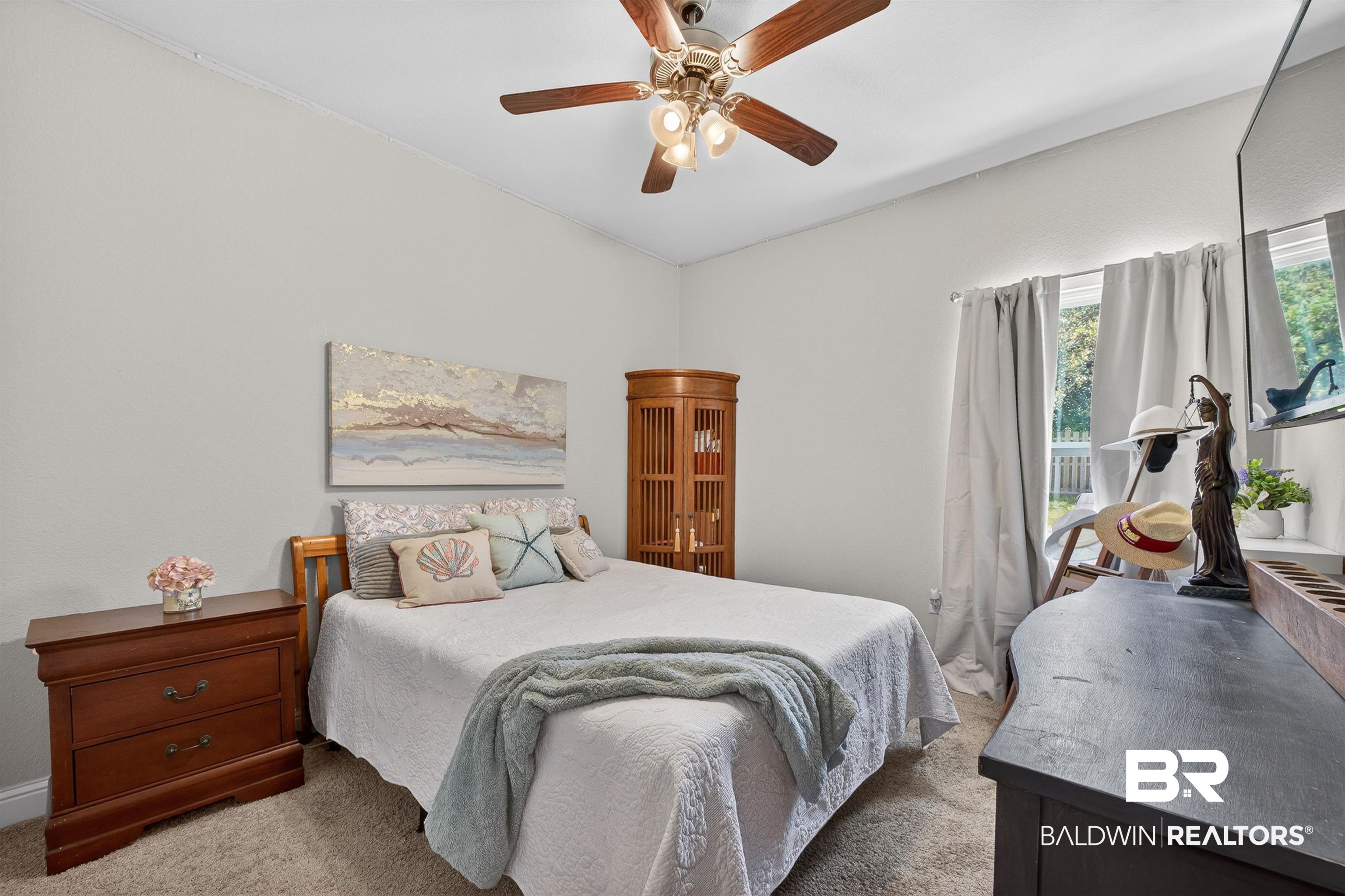 8735 Bronze Lane Foley, AL 36535 - Photo 33 of 58 Carpeted room featuring a ceiling fan with integrated lighting, a window with exterior views, and neutral wall paint