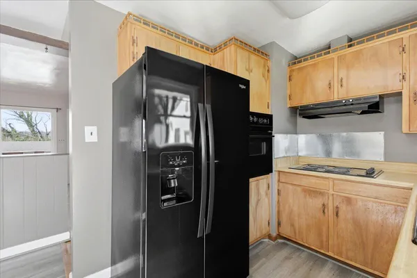 a kitchen with a refrigerator stove and cabinets