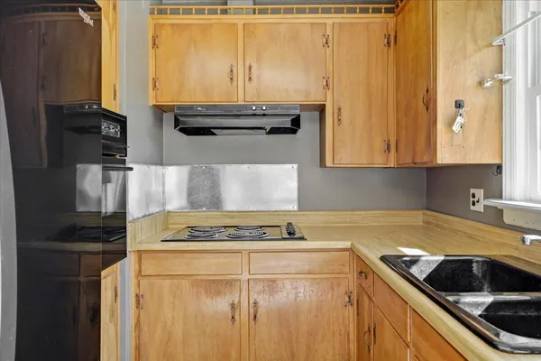 a kitchen with granite countertop cabinets and steel stainless steel appliances