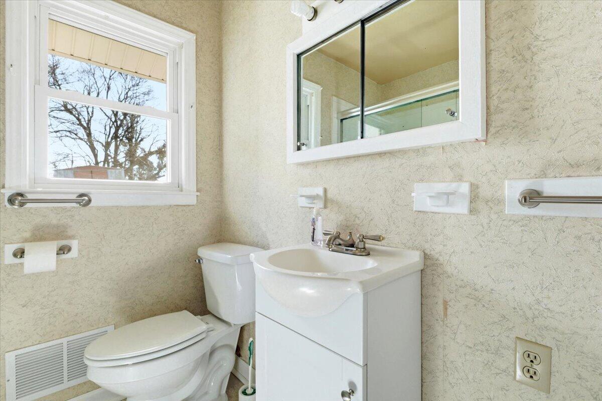212 Cherryhill Road Northwest Roanoke, VA 24017 - Photo 19 of 30 a bathroom with a toilet a sink and a mirror