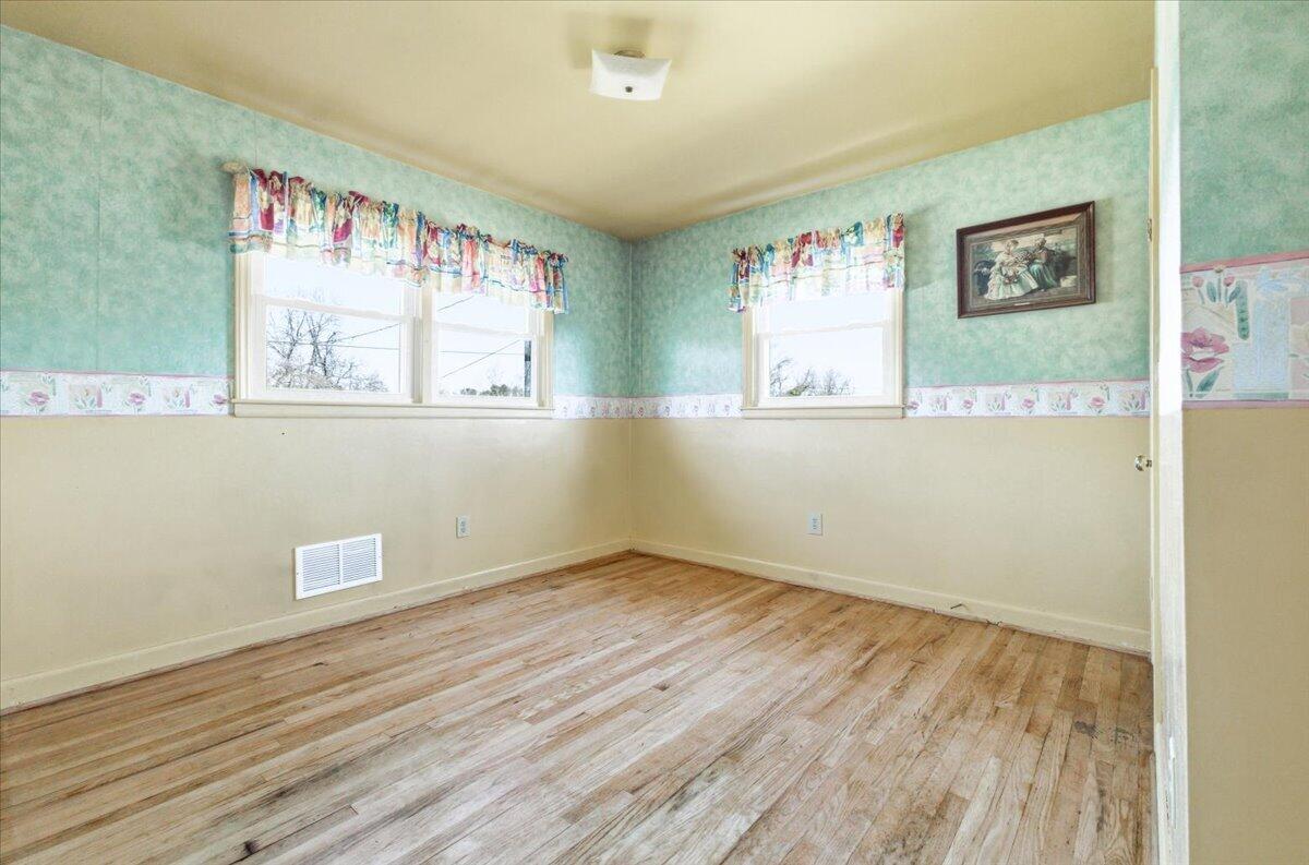 212 Cherryhill Road Northwest Roanoke, VA 24017 - Photo 23 of 30 an empty room with wooden floor and windows