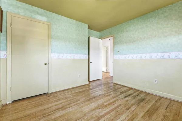 a view of room with window and hardwood floor