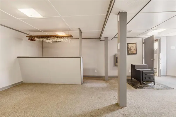 a view of a hallway with wooden shelves and door