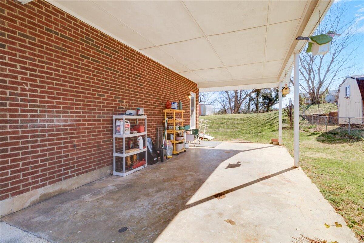 212 Cherryhill Road Northwest Roanoke, VA 24017 - Photo 4 of 30 a view of a patio with a table and chairs under an umbrella