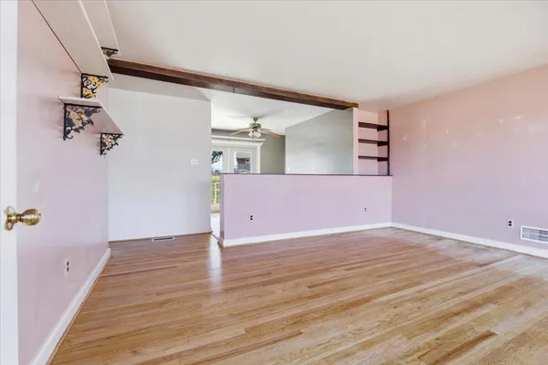 a view of a room with wooden floor and staircase
