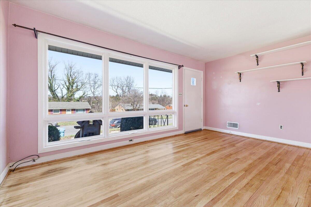 212 Cherryhill Road Northwest Roanoke, VA 24017 - Photo 7 of 30 a view of an empty room with wooden floor and a window