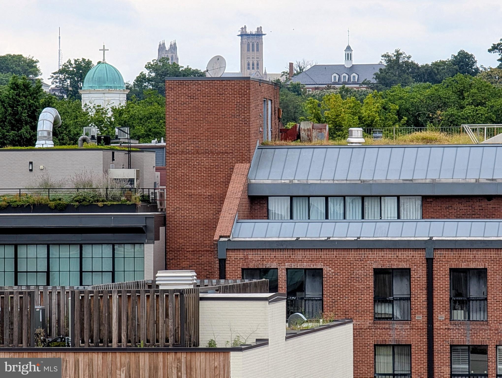 1080 Wisconsin Avenue Northwest, Unit 501 Washington, DC 20007 - Photo 13 of 36 a front view of a house with a yard