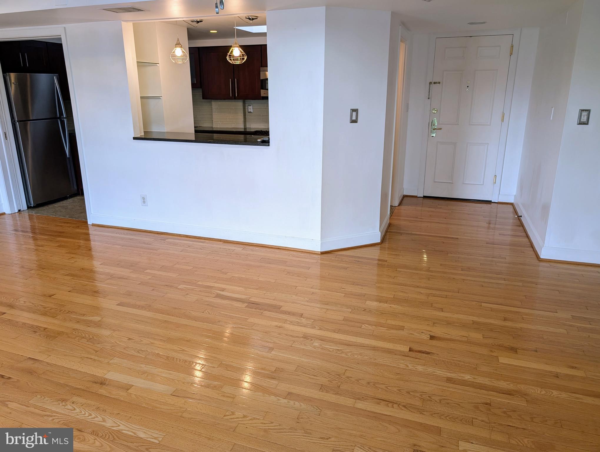 1080 Wisconsin Avenue Northwest, Unit 501 Washington, DC 20007 - Photo 14 of 36 a view of a hallway with wooden floor
