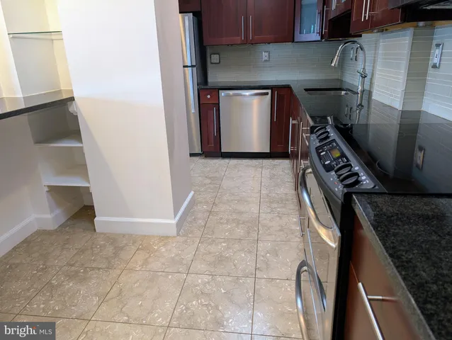 a kitchen with stainless steel appliances a sink stove and refrigerator
