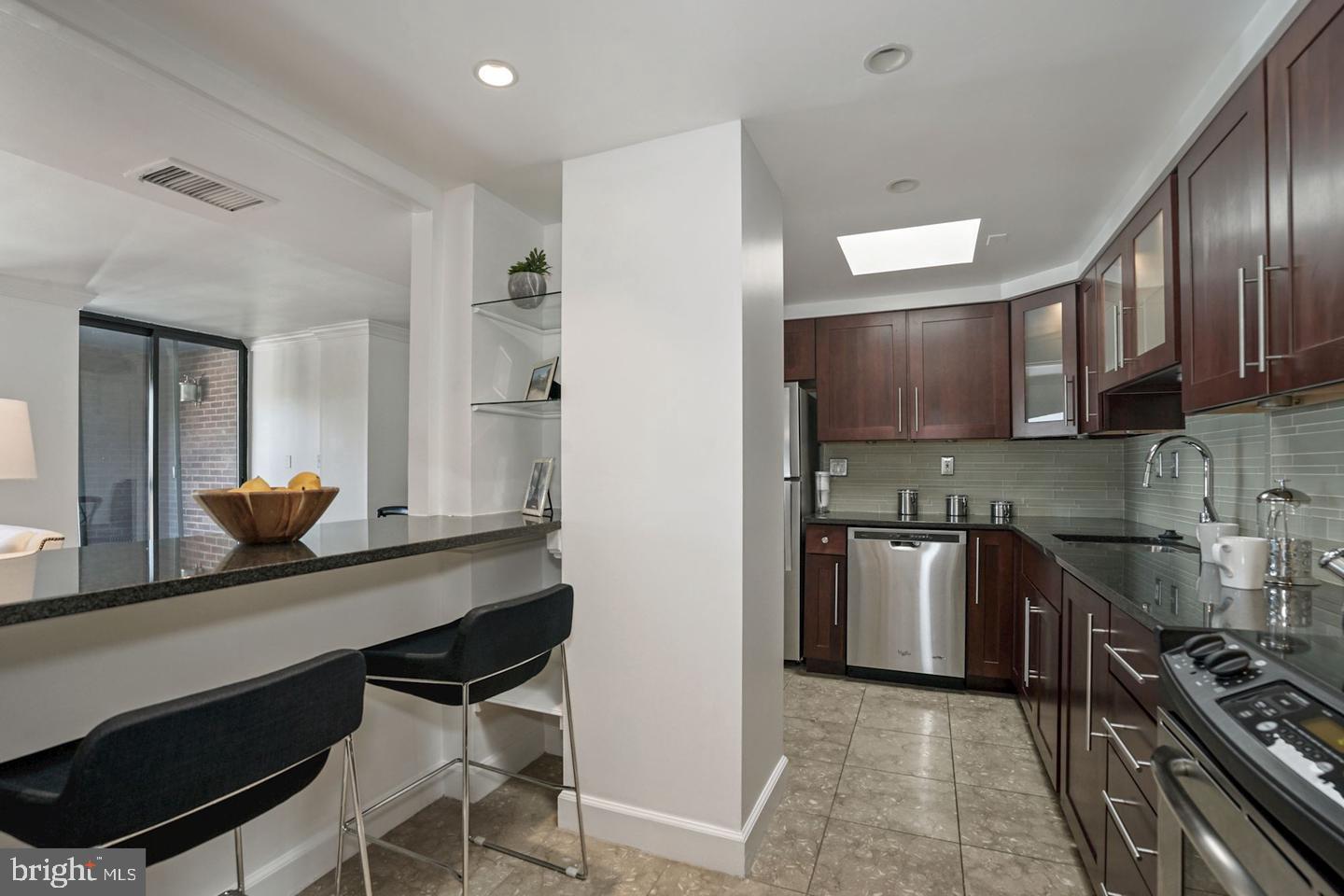 1080 Wisconsin Avenue Northwest, Unit 501 Washington, DC 20007 - Photo 16 of 36 a kitchen with stainless steel appliances a sink stove and refrigerator