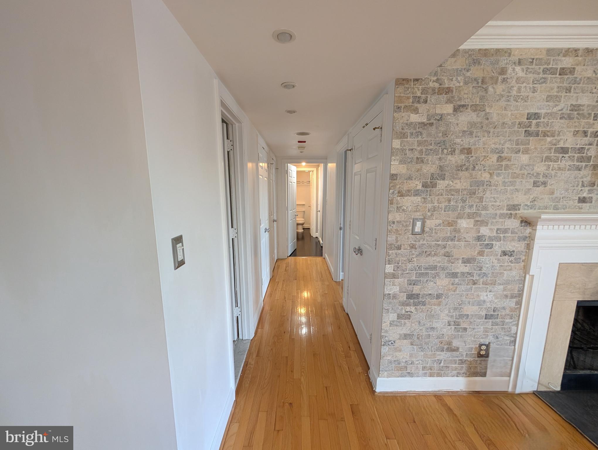 1080 Wisconsin Avenue Northwest, Unit 501 Washington, DC 20007 - Photo 17 of 36 a view of a hallway with wooden floor and staircase