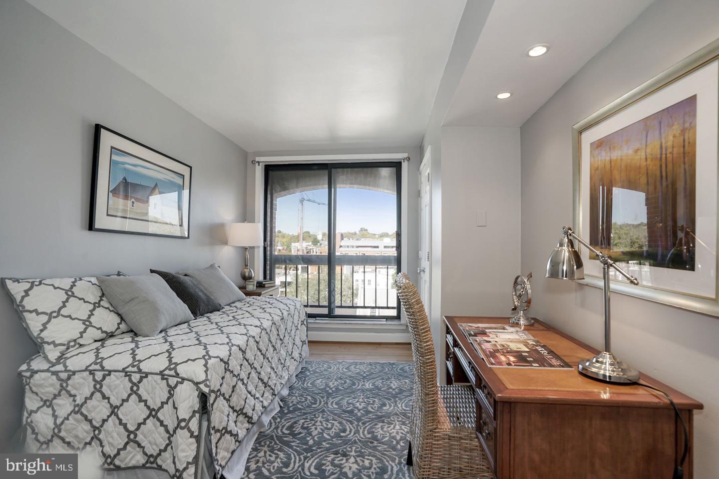 1080 Wisconsin Avenue Northwest, Unit 501 Washington, DC 20007 - Photo 22 of 36 a bedroom with a bed and a flat screen tv