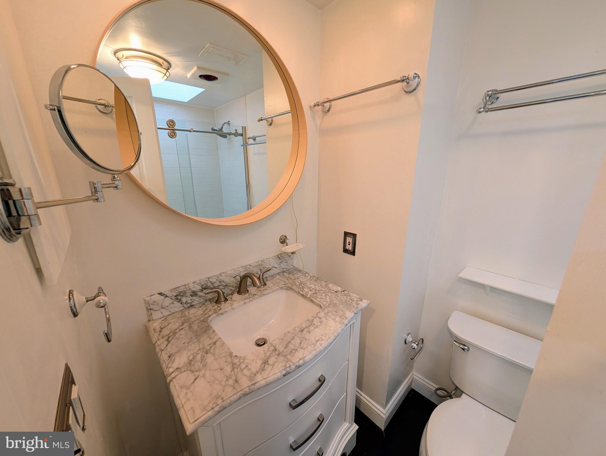 1080 Wisconsin Avenue Northwest, Unit 501 Washington, DC 20007 - Photo 25 of 36 a bathroom with a sink and a mirror