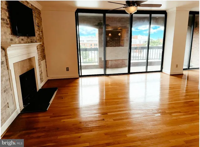 a view of a living room with an empty space and a fireplace