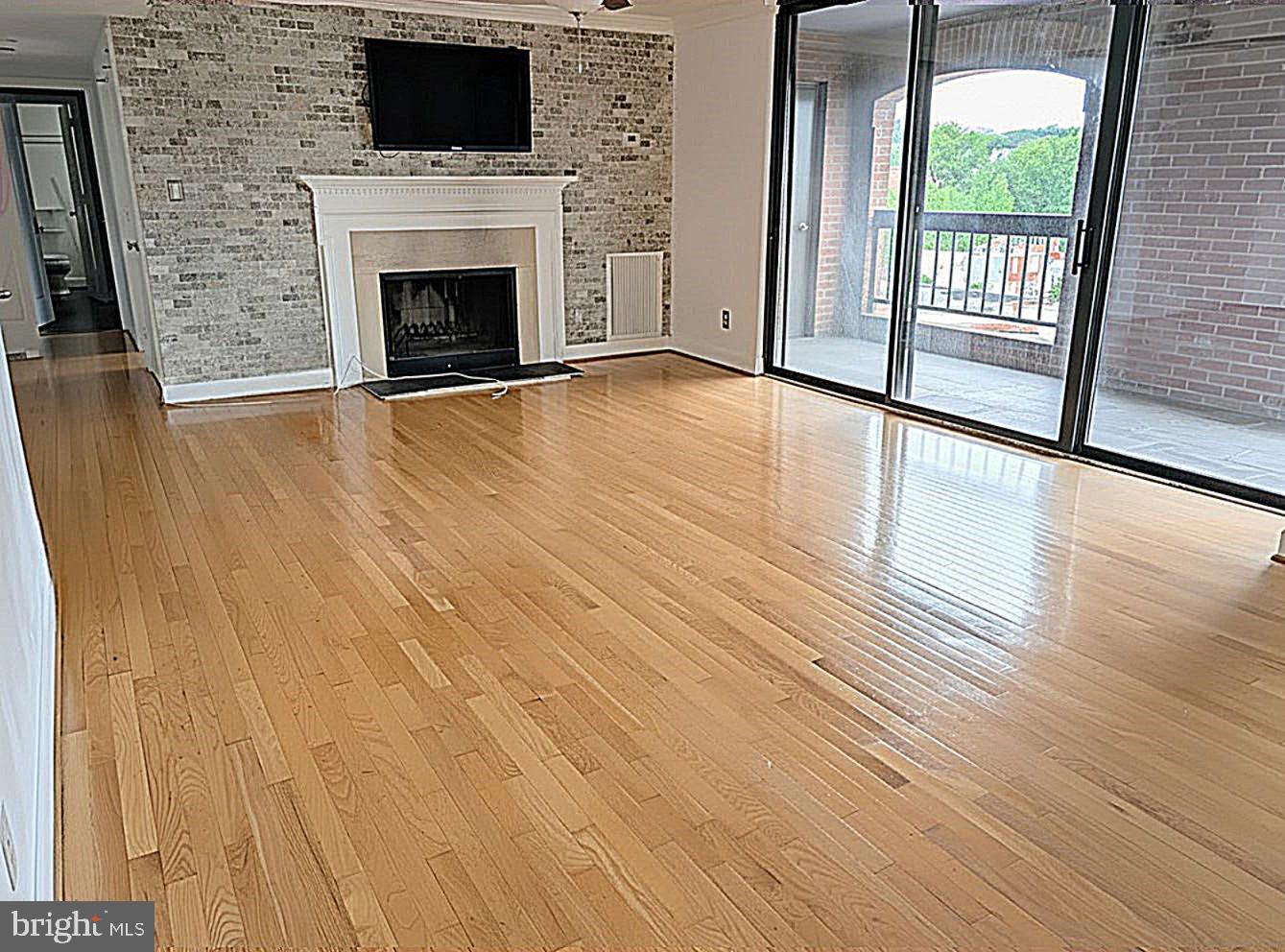 1080 Wisconsin Avenue Northwest, Unit 501 Washington, DC 20007 - Photo 7 of 36 a view of an empty room with wooden floor and a window