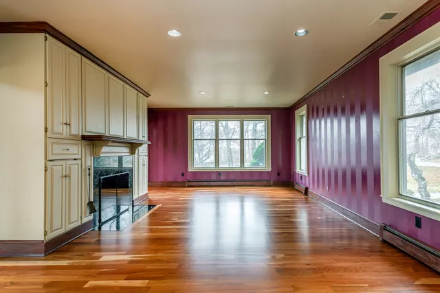 a view of a kitchen with wooden floor and a window