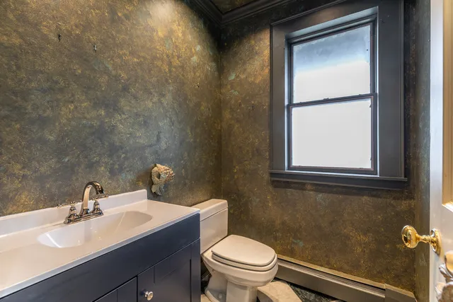 a bathroom with a sink toilet and mirror