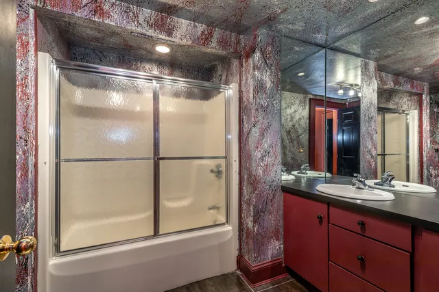 an empty room with windows and chandelier