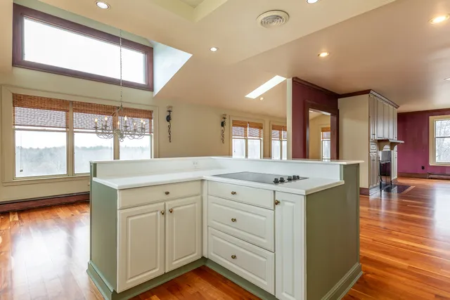 a spacious bathroom with a granite countertop sink and a large mirror