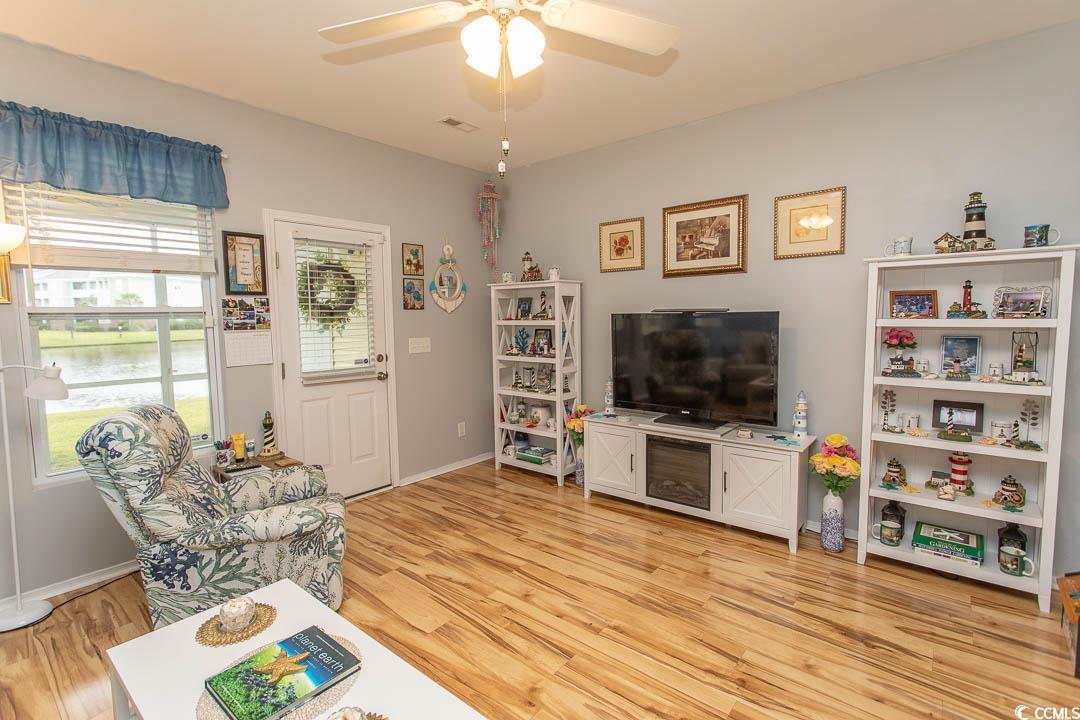 328 Kiskadee Loop, Unit E Conway, SC 29526 - Photo 4 of 37 Living room featuring light wood-type flooring, a water view, and a ceiling fan
