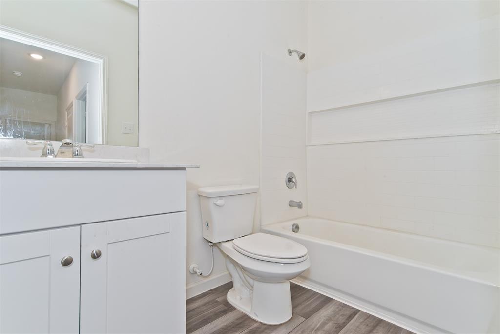 1637 Shadow Hawk Drive Fort Worth, TX 76052 - Photo 16 of 20 a bathroom with a toilet and a bathtub