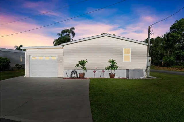 a front view of a house with a garden and plants