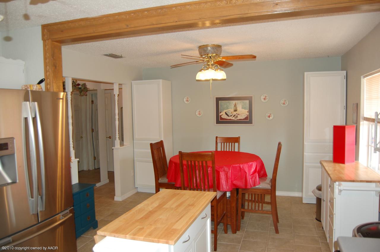 6706 Hatton Road Amarillo, TX 79110 - Photo 11 of 23 a view of a dining room with furniture and a chandelier