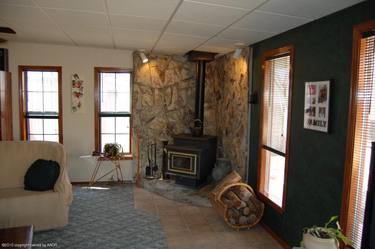 6706 Hatton Road Amarillo, TX 79110 - Photo 19 of 23 a living room with furniture windows and a fireplace