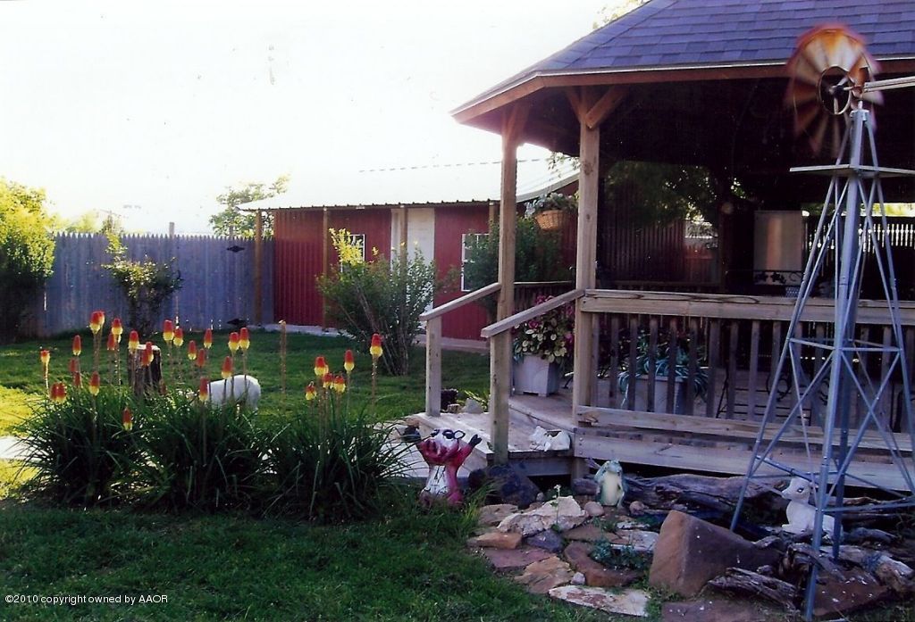 6706 Hatton Road Amarillo, TX 79110 - Photo 5 of 23 a view of a chair and tables in patio with a small yard