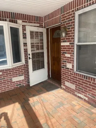 a view of a brick house with an empty space