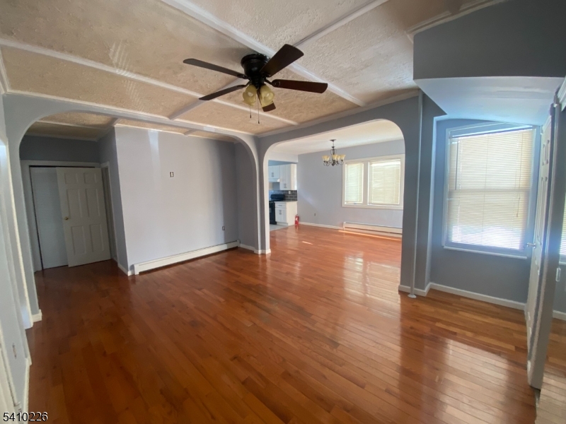 17 Walnut Terrace Bloomfield, NJ 07003 - Photo 4 of 12 a view of an empty room with wooden floor and a window
