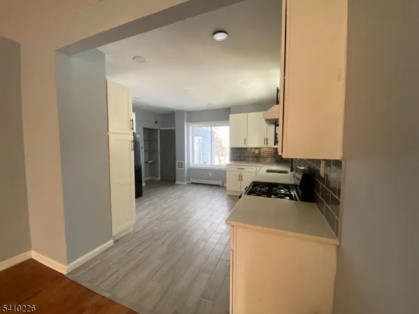 a kitchen with a refrigerator and a stove top oven