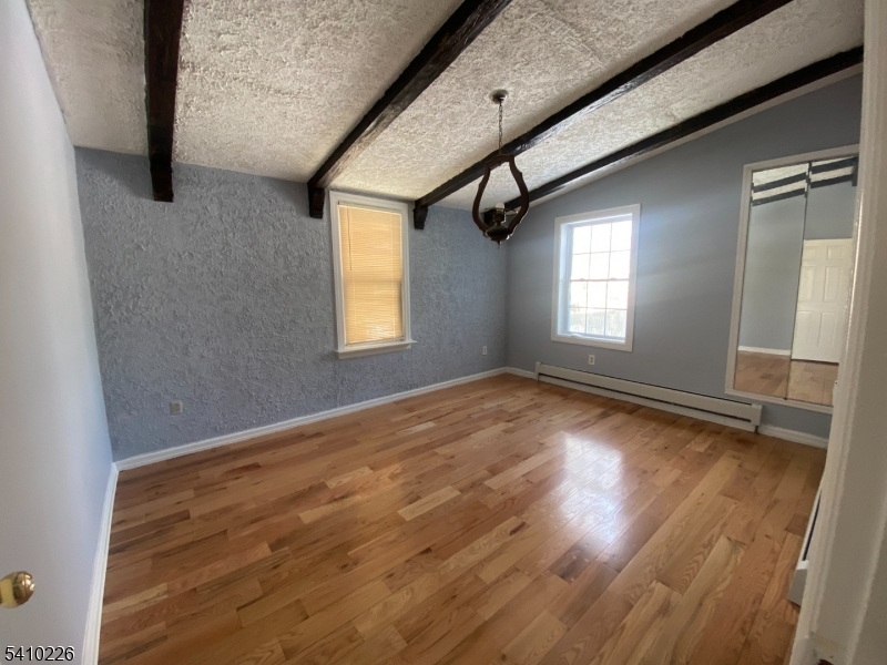 17 Walnut Terrace Bloomfield, NJ 07003 - Photo 9 of 12 a view of empty room with wooden floor and fan