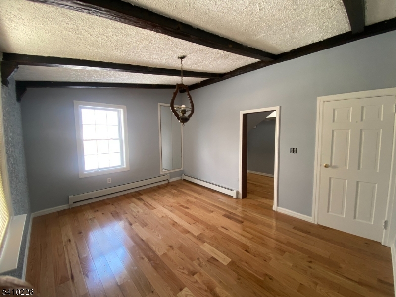 17 Walnut Terrace Bloomfield, NJ 07003 - Photo 10 of 12 an empty room with wooden floor and windows