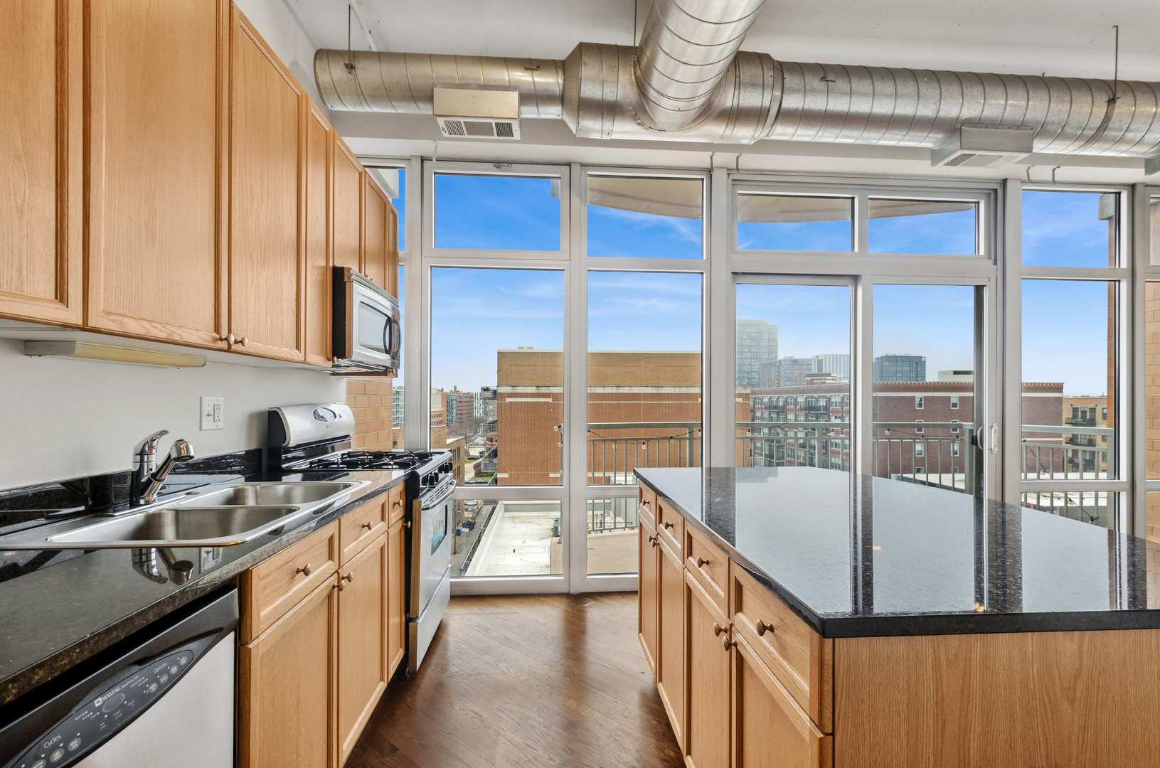 950 West Monroe Street, Unit 809 Chicago, IL 60607 - Photo 7 of 21 a kitchen with a sink a stove and cabinets