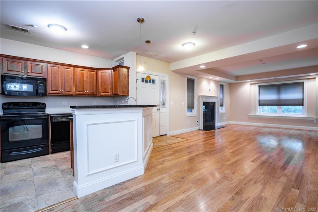 a kitchen with stainless steel appliances granite countertop a stove cabinets and a sink