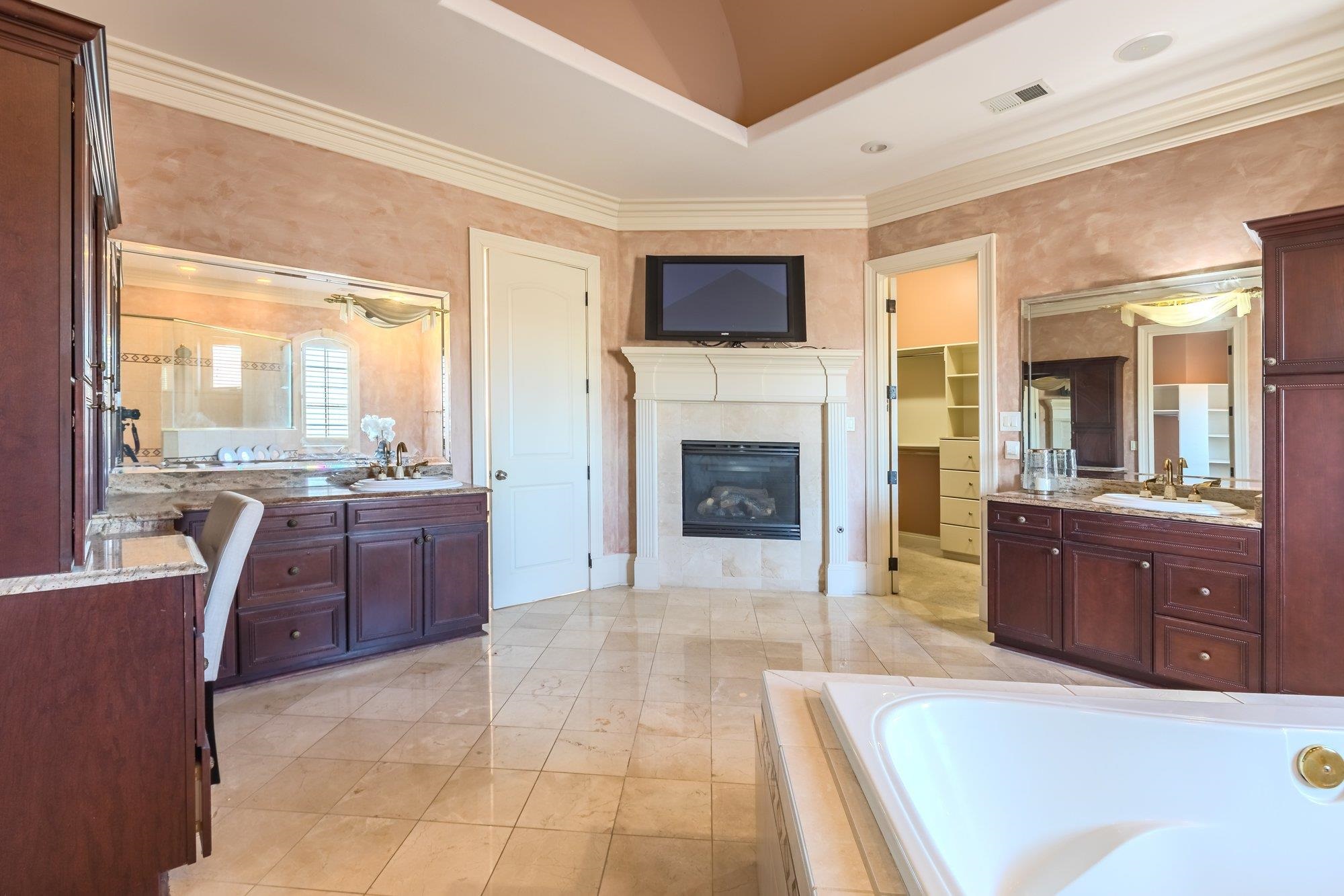 2535 Preakness Drive Eads, TN 38028 - Photo 18 of 34 a spacious bedroom with a large bed and a fireplace