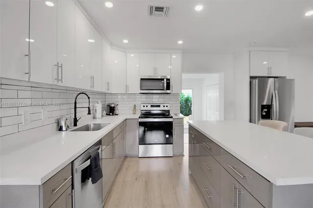 a kitchen with a sink stove and refrigerator
