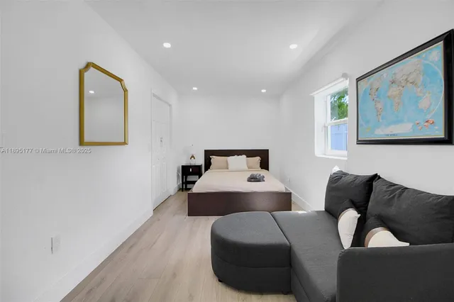 a bedroom with a bed and couch