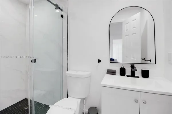 a bathroom with a sink a toilet and a mirror