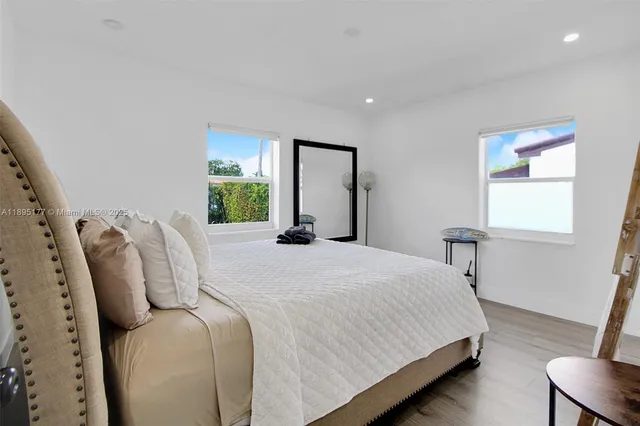 a bedroom with bed and window