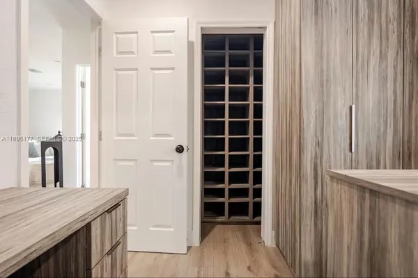 a view of walk in closet and empty room