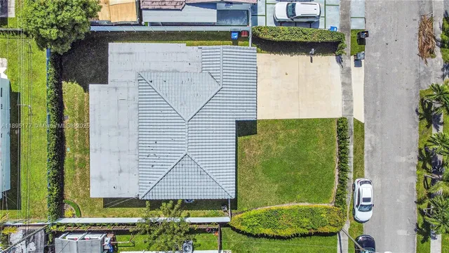 an aerial view of a houses with a swimming pool