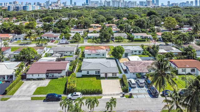 an aerial view of a house with a garden and lake view